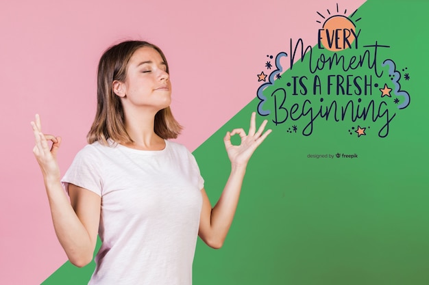 Young woman meditating next to positive quote