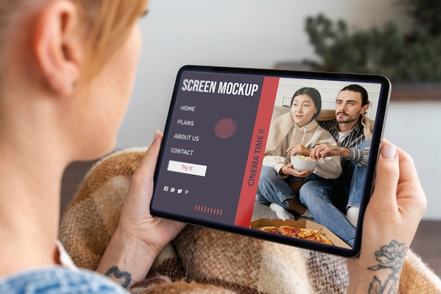 Young woman watching a movie on her tablet