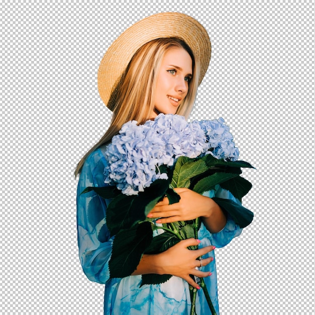 Young woman with blue hedragea buquet in blue dress standing in green garden on sunset
