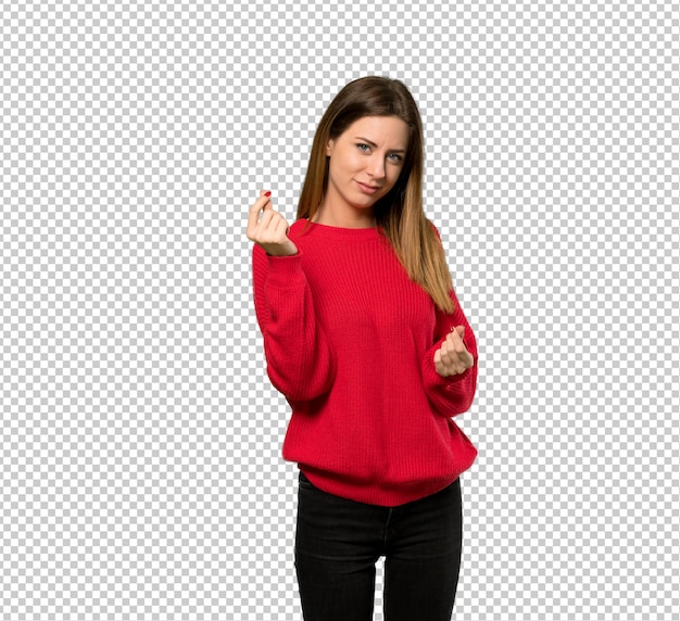 Young woman with red sweater making money gesture