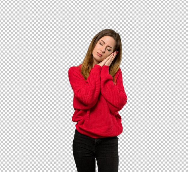 Young woman with red sweater making sleep gesture in dorable expression