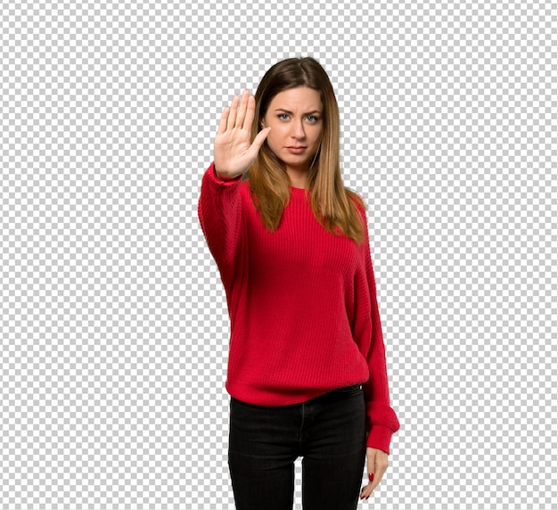 PSD young woman with red sweater making stop gesture denying a situation that thinks wrong