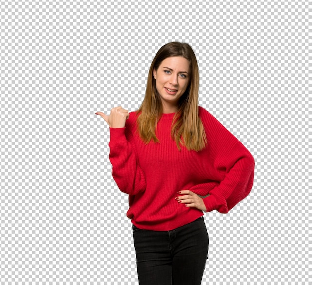 PSD young woman with red sweater pointing to the side to present a product