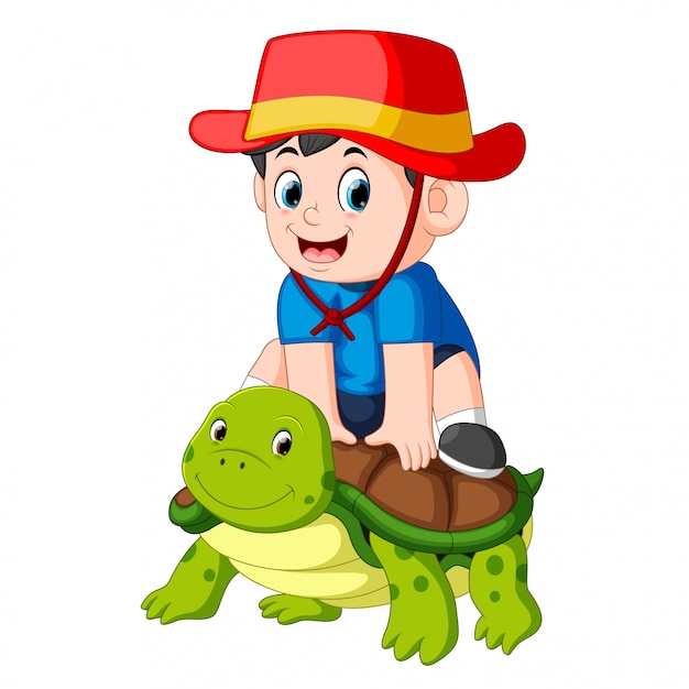 Мальчик сидит на большой черепахе