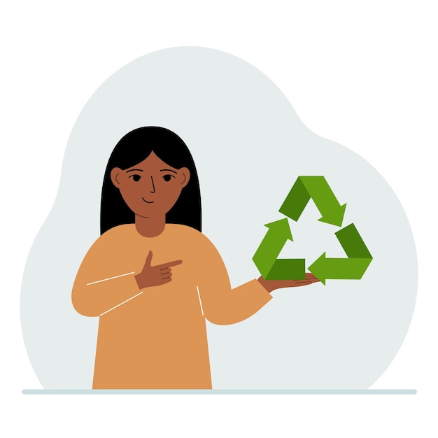 어린 소녀가 손에 녹색 재활용 재활용 또는 생태 기호를 들고 있습니다.