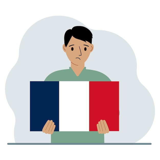 男は手にフランス国旗を持っているデモンストレーションの国民の祝日や愛国心のコンセプト