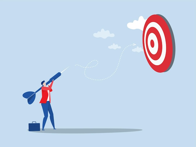 achieve target concept businessman holding dart to target bullseye