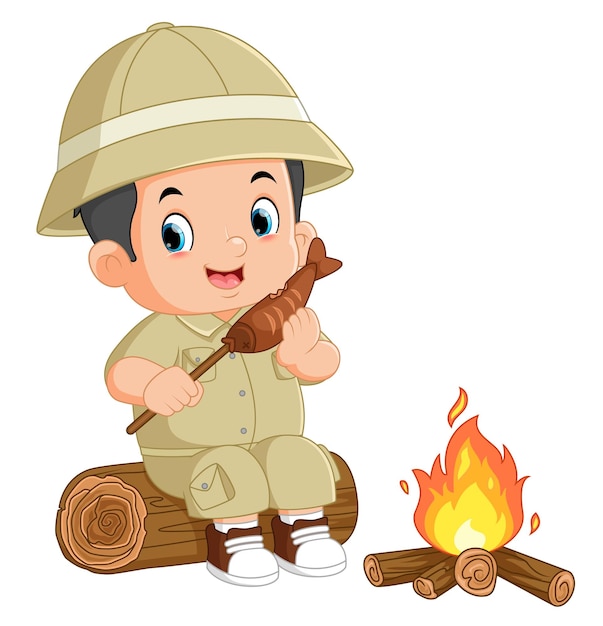 An adventurous boy sits on a fallen tree and is eating grilled fish in front of a bonfire