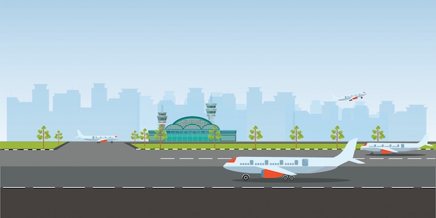 Airport building and airplanes on runway.