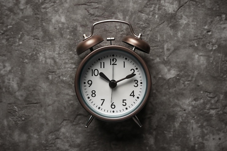 Vector alarm clock on nature background time change concept