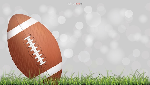 American football ball or rugby football ball on green grass court