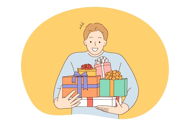 Anniversary, Birthday or Christmas present, celebration concept. Young happy man man carrying heap