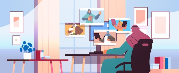 Arab businessman discussing with colleagues in web browser windows during video call virtual conference