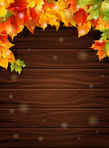 Autumn leaves against the dark wooden boards background