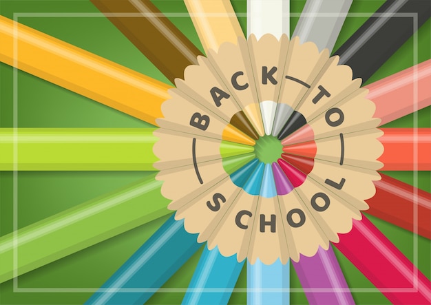 緑の背景に円形の配置で現実的な多色木製色鉛筆で学校概念に戻る。