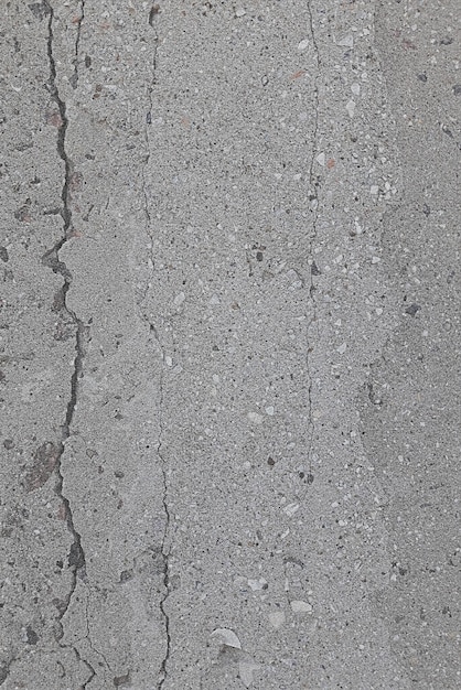 Фонная текстура бетона серого цвета с каменными частицами бетонные трещины