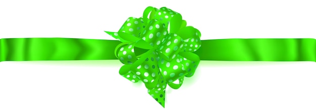 Beautiful big horizontal bow made of green ribbon in polka dots with shadow on white background