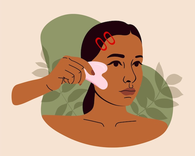 Beautiful woman massaging face with gua sha jade scraper. Girls beauty routine for skin care.
