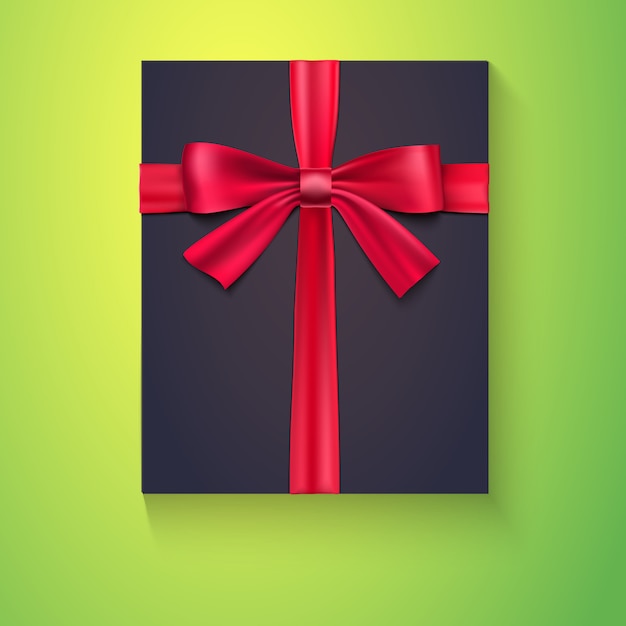 Black box with red ribbon and bow on green