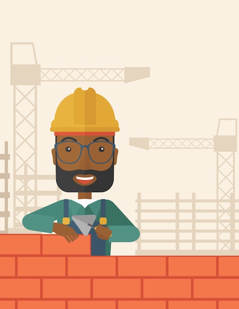 Black builder man is building a brick wall.