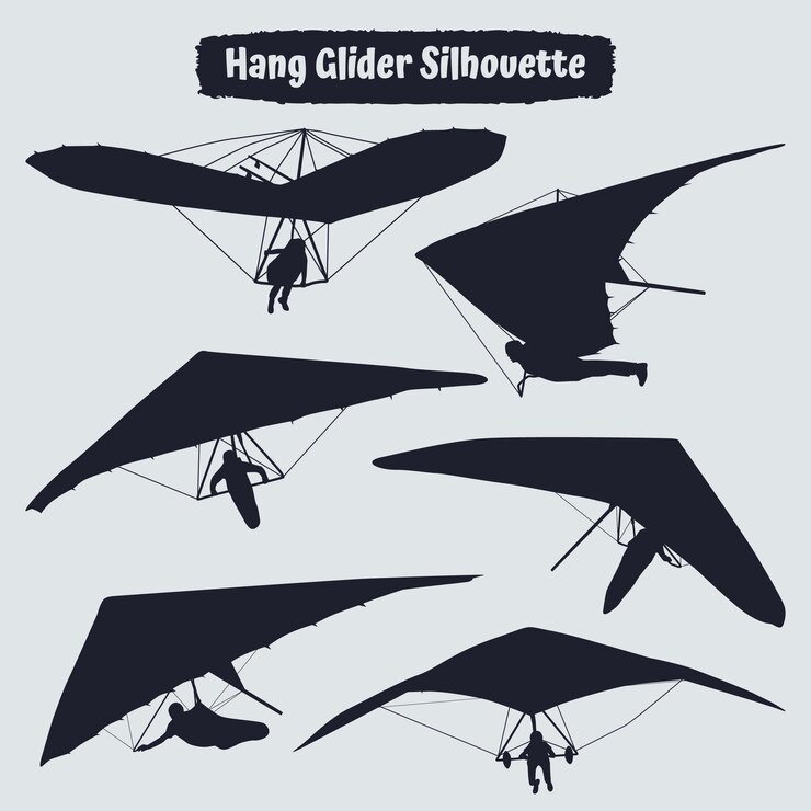 Black silhouettes hang glider or parachute skydiving