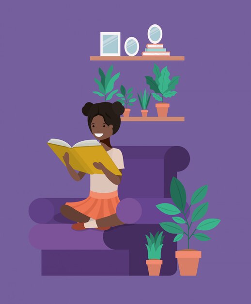 Black student girl sitting reading book in livingroom