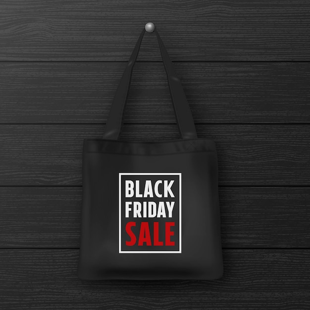 나무 검은색 벽에 BLACK FRIDAY SALE 근접 촬영이 새겨진 검은색 직물 토트 백