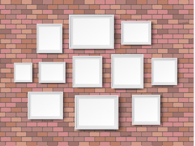 Blank picture frames on red brick wall