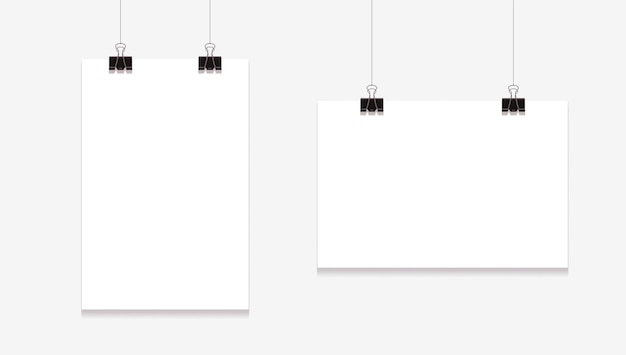 Blank posters mockup. sheets hanging on binders on white background.