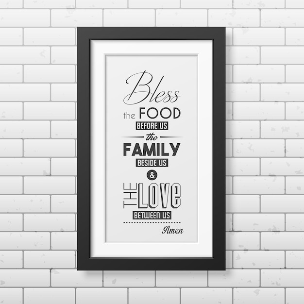 Bless the food before us - typographical quote in realistic square black frame on the brick wall.