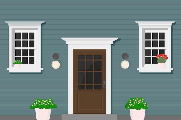 A blue wooden house with white windows and white door with flowers