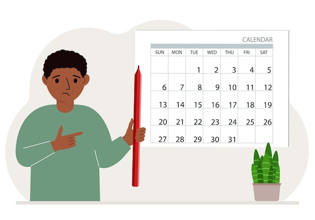 The boy holds a red pencil and stands near a large calendar