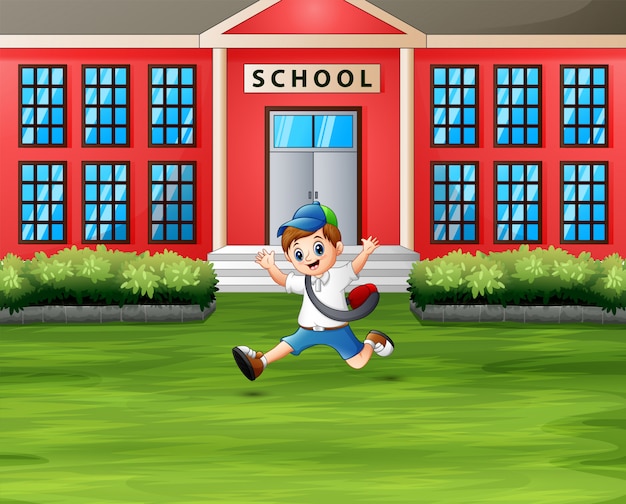 A boy jumping in front the school building