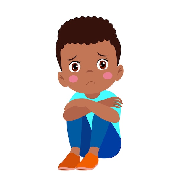 A boy sitting on the floor with a sad face.