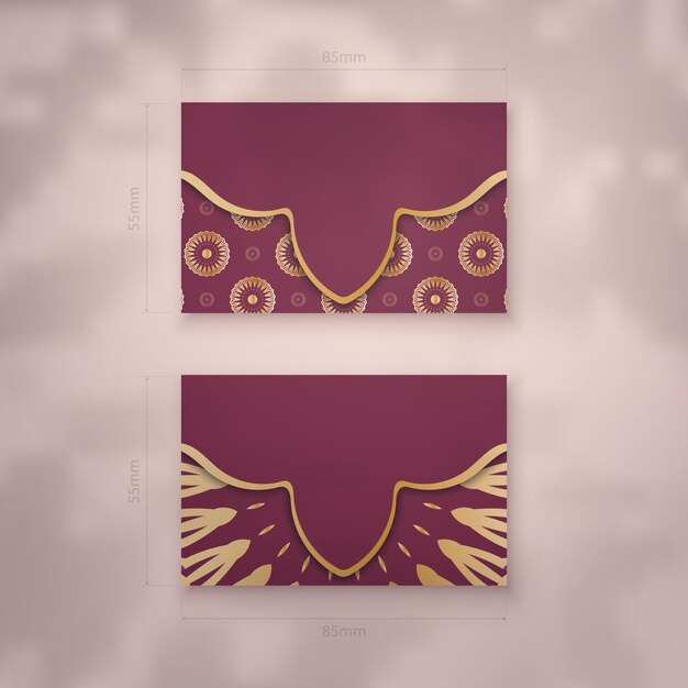 Burgundy business card with Indian gold ornaments for your business.