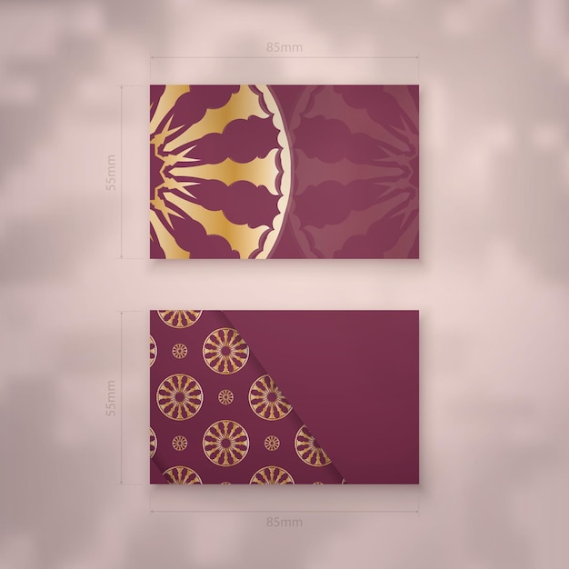 Burgundy business card with Indian gold pattern for your business.