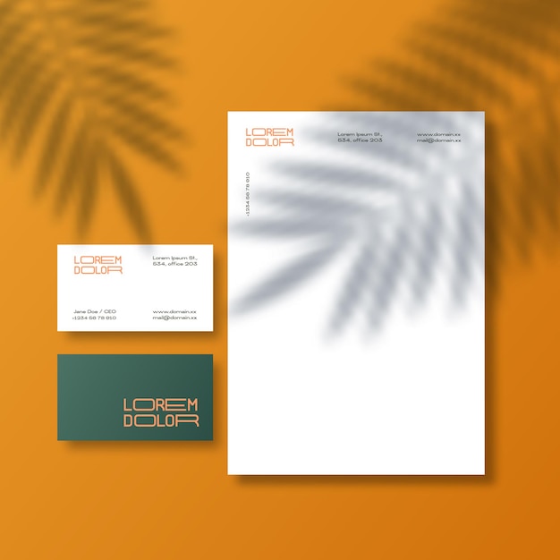 Vector business cards and letterhead background with a palm leaves shadow overlay. realistic vector stationary mockup scene with natural lighting on top.