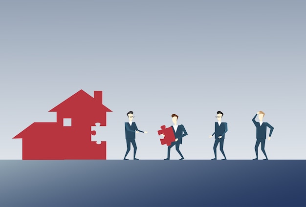 business people group collecting house from puzzle parts 