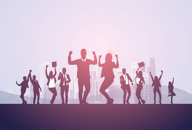 Business people group silhouette excited hold hands up raised arms