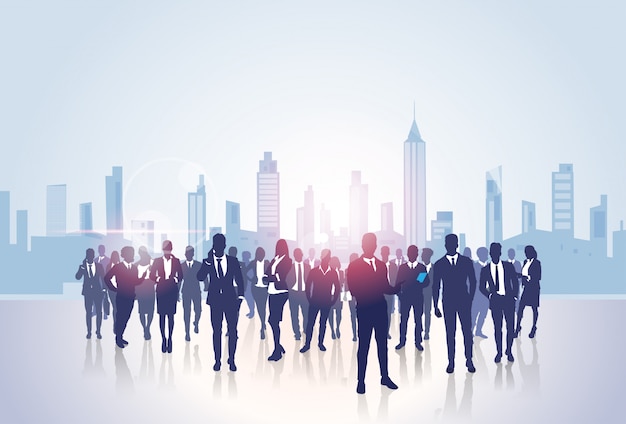 Business people group silhouettes over city landscape modern office buildings