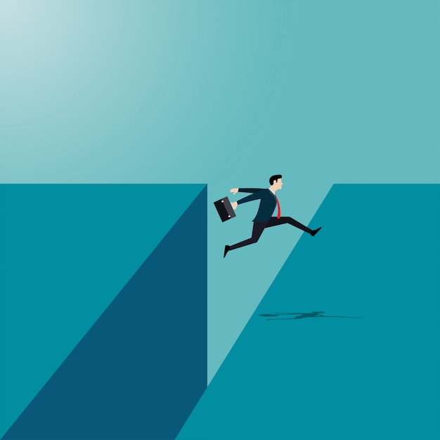 Businessman jumping reach the other side of the cliff