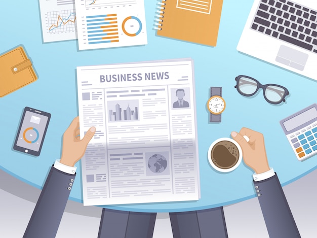 Businessman reading a newspaper in the workplace and drinks coffee.