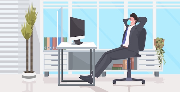 Businessman sitting at workplace desk social distancing coronavirus epidemic protection self isolation remote work concept office interior horizontal