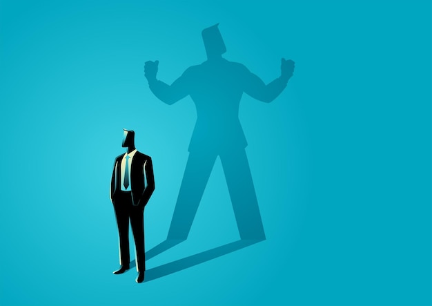 Businessman standing and casting a shadow of a strong superhero