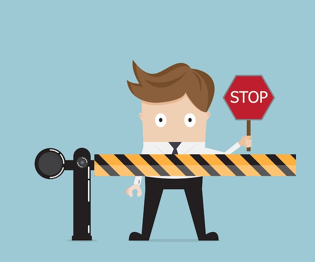 businessman standing at road barrier and holding stop sign 