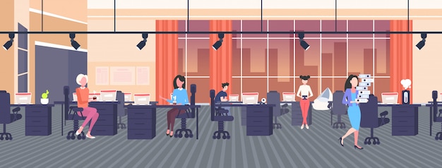 Businesswomen at workplace in creative co-working open space center working process concept modern workspace office interior  horizontal full length