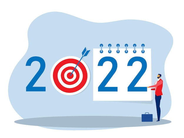 a calendar plan goal 2022 A businessman tears off a calendar sheet of the outgoing year