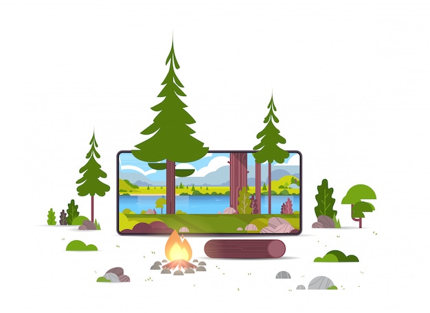 campfire in wild summer forest beautiful river mountains landscape nature tourism camping or hiking concept smartphone screen online mobile application 