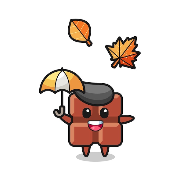 Vector cartoon of the cute chocolate bar holding an umbrella in autumn