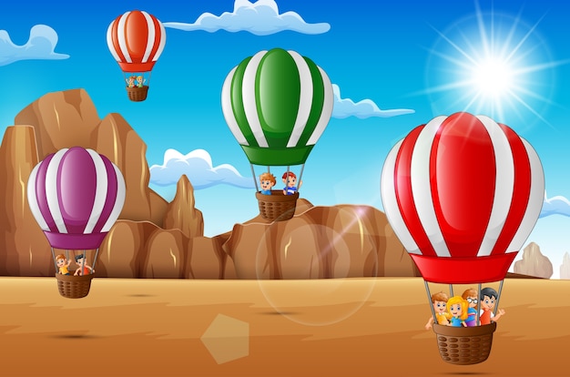 Cartoon happy kids riding hot air balloon in the desert